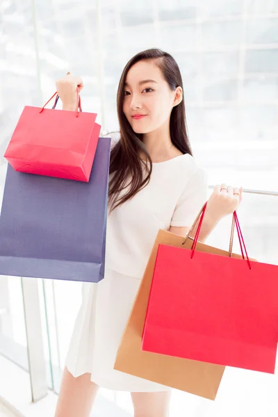 Portrait young adult girl with colored bags — Stock Photo, Image