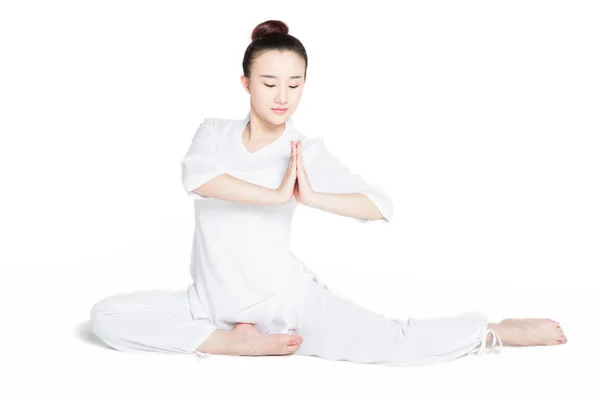 Frau sitzt auf dem Boden und übt Yoga — Stockfoto