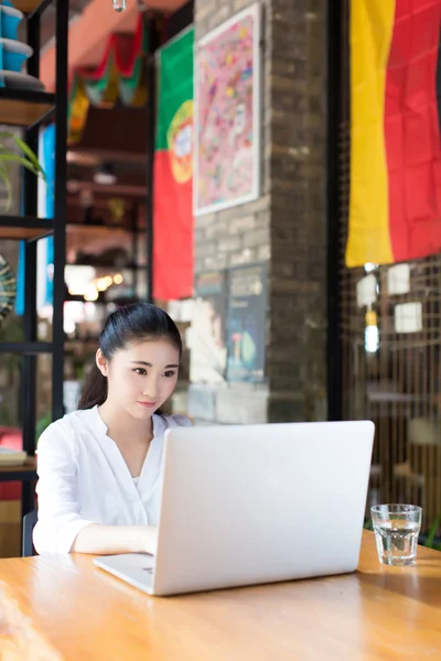 Beautiful hipster woman using laptop at cafe — Stock Photo, Image