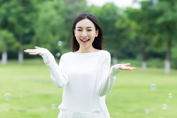 Pretty girl and colorful bubbles — Stock Photo, Image