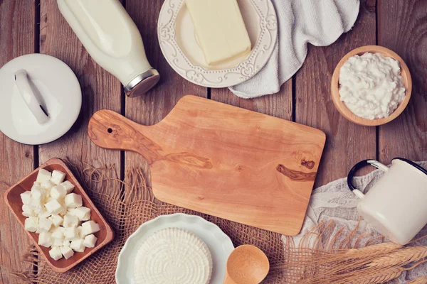 Milk, cheese and butter with board — Stock Photo, Image