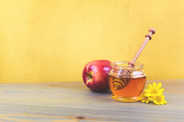 Honey jar and apple