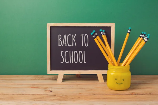 Chalkboard and pencils in emoji jar — Stock Photo, Image