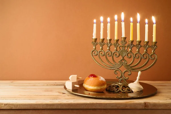 Jewish holiday Hanukkah concept with vintage menorah and candles on wooden table