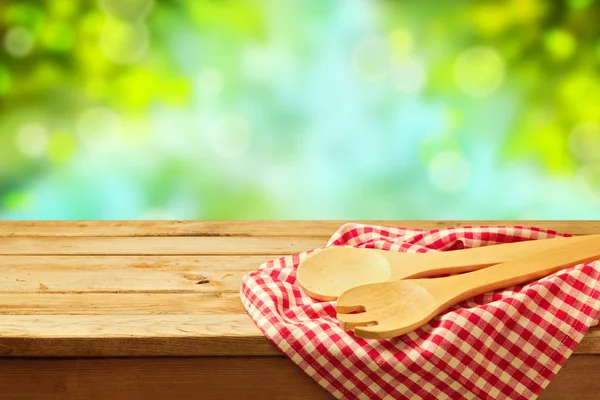 Kitchen utensil over garden bokeh background — Stock Photo, Image