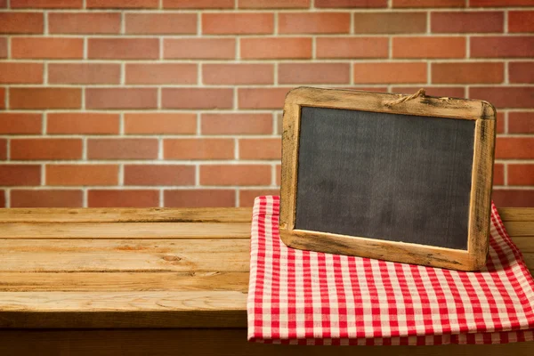 Chalkboard on checked tablecloth — Stock Photo, Image