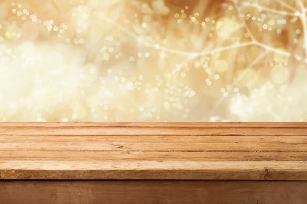 Golden bokeh background with wooden table — Stock Photo, Image