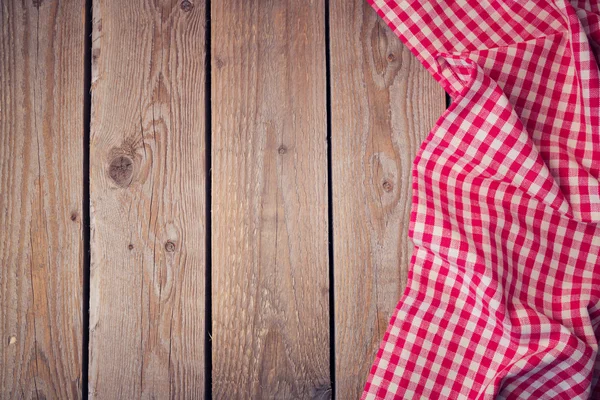 Wooden old table with checked tablecloth — Stock Photo, Image