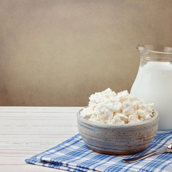 Cottage cheese and jug with milk