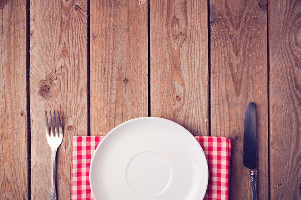 Wooden table with empty plate