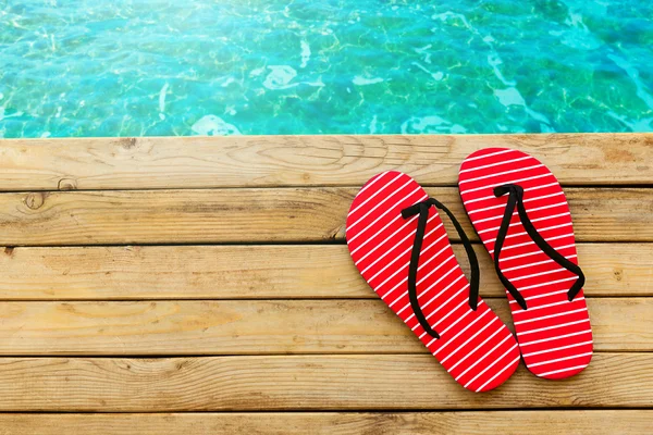 Flip flops on wooden deck — Stock Photo, Image