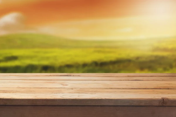 Wooden table over blur landscape — Stock Photo, Image
