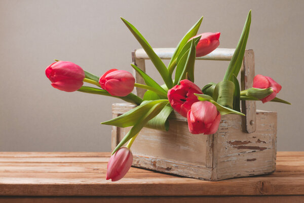 Tulip flowers in wooden bo