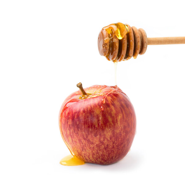 Apple and honey on wooden stick