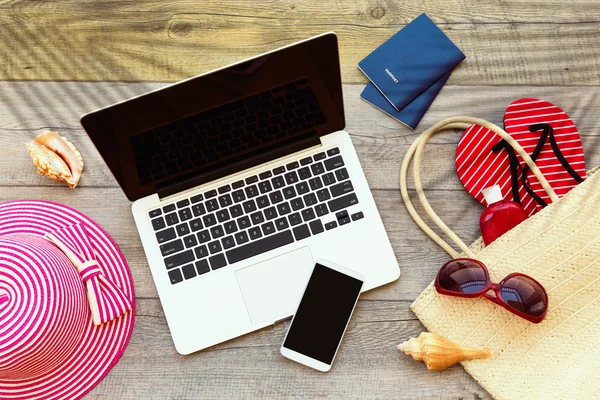 Laptop und Smartphone mit Strandzubehör — Stockfoto