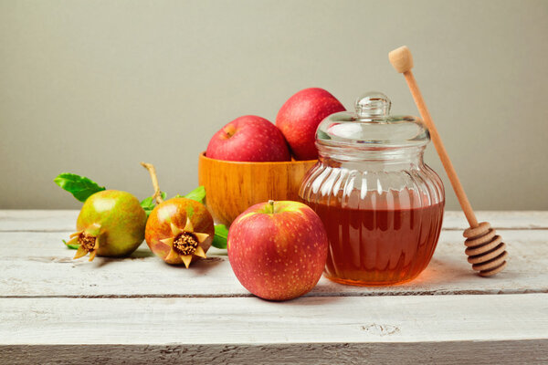 Honey jar and apples with pomegranate