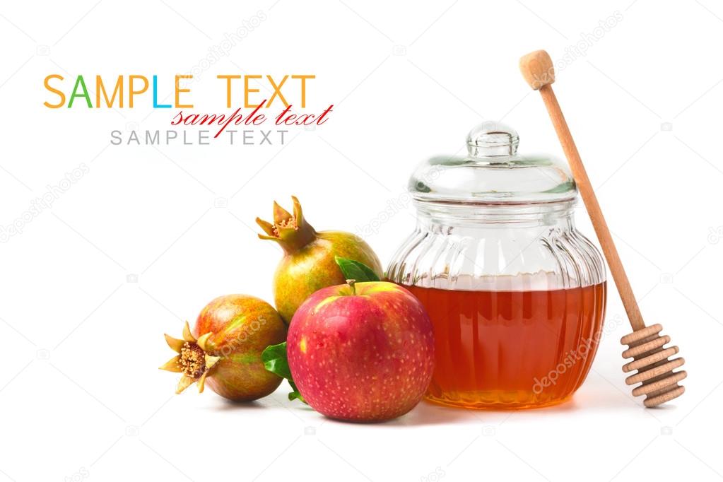 Honey jar and fresh apples with pomegranate