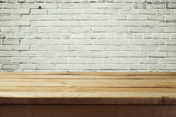 Table en bois vide et mur de briques — Photo