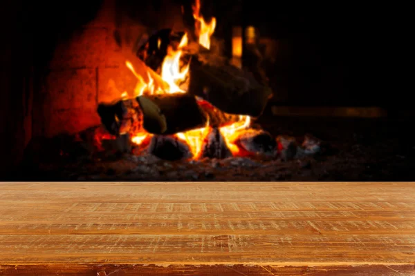 Wooden table over fireplace — Stock Photo, Image