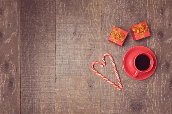 Cup with candy canes and gift boxes — Stock Photo, Image