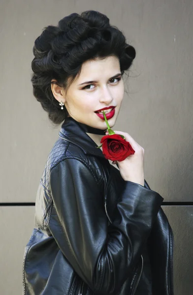 Woman in leather jacket with rose — Stock Photo, Image