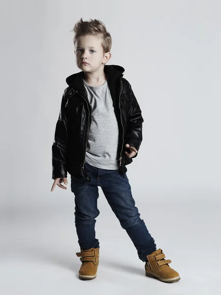 Bambino alla moda in cappotto di pelle.little boy hairstyle.funny bambino — Foto Stock