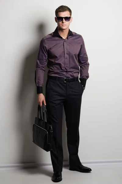 fashionable man with handbag
