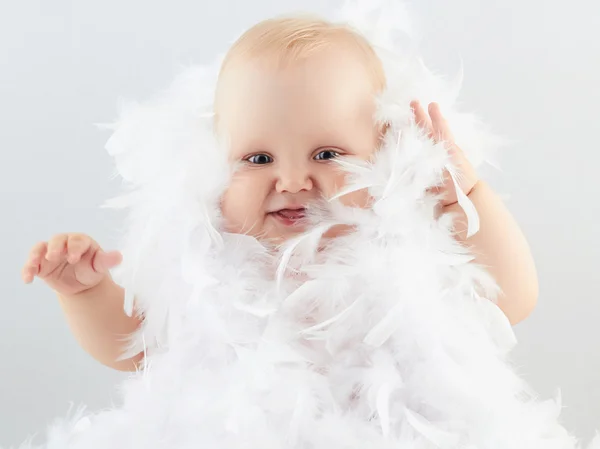 Smiling baby girl in feathers. little funny child.newborn — Stock Photo, Image