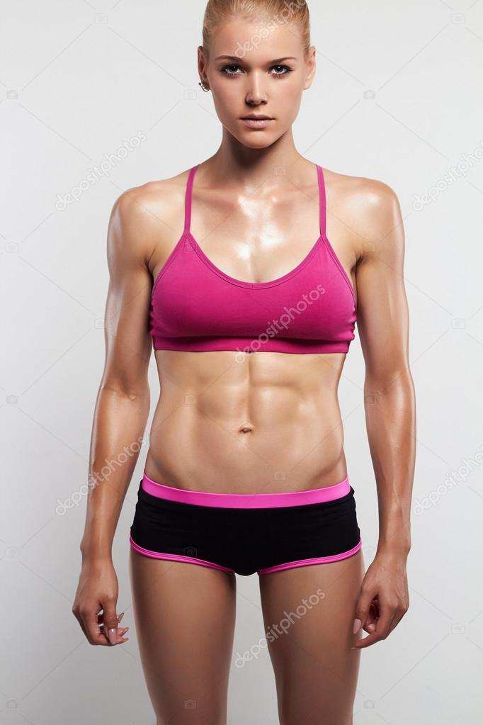 Athletic girl.muscular fitness woman, trained female body.healthy lifestyle  Stock Photo by ©EugenePartyzan 118451668