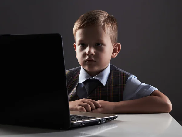 Young boy looking in the notebook screen. funny child with computer — Stock Photo, Image