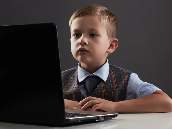 Young boy looking in the notebook screen. funny child with computer — Stock Photo, Image