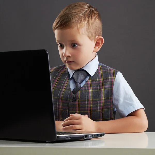 Young boy looking in the notebook screen. funny child with computer — Stock Photo, Image