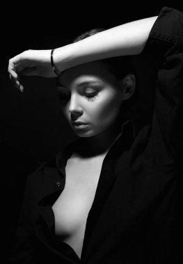 Gölge altındaki genç güzel bir kadının siyah beyaz portresi. Siyahlı seksi kız