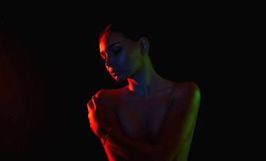 Renkli parlak ışıklar içinde güzel genç bir kadın. Kız silueti 