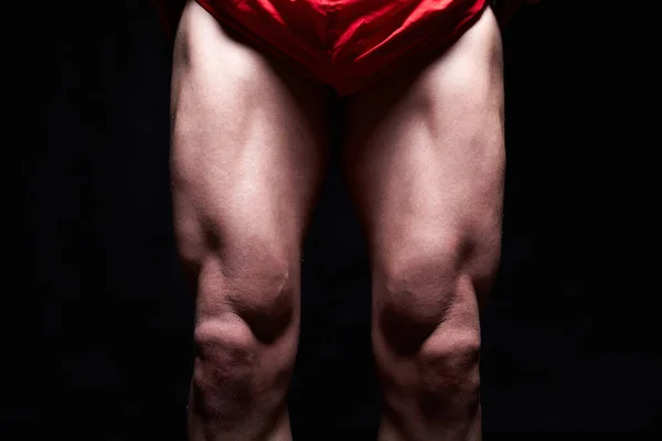male muscular legs. body-building. muscle man in red sport panties
