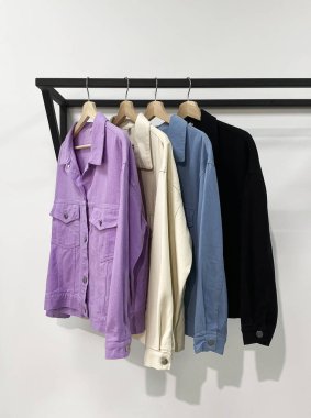 Mağazadaki askıda kadın kot ceketleri var. Bayan giyim hala hayattadır. vitrin