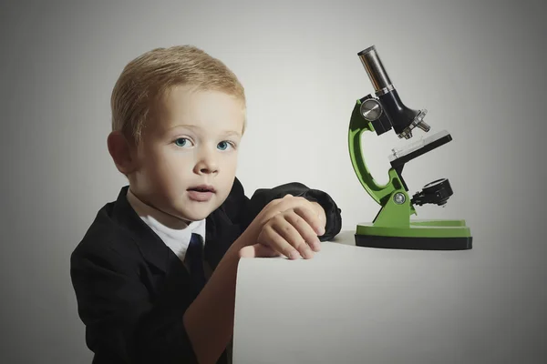 Funny child.little scientist.fashion portrait of little boy in tie.Schoolboy working with a microscope.Smart kid.Education — Stock Photo, Image