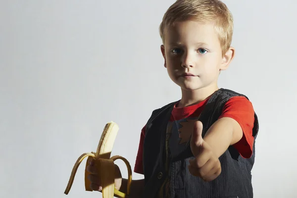 Funny Child eating Banana.Happy Little Boy. Health food. Fruits.Vitamin — Stock Photo, Image