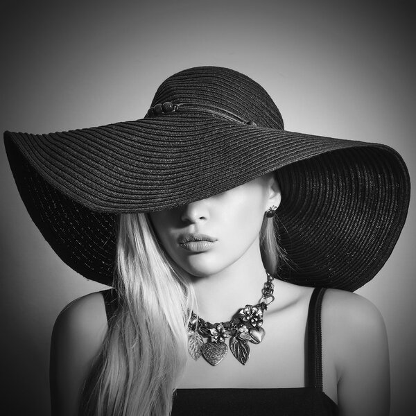 Monochrome portrait of Beautiful Blond Woman in Black Hat. Close-up. Elegance Beauty Girl.Accessories. Lady in Jewelry
