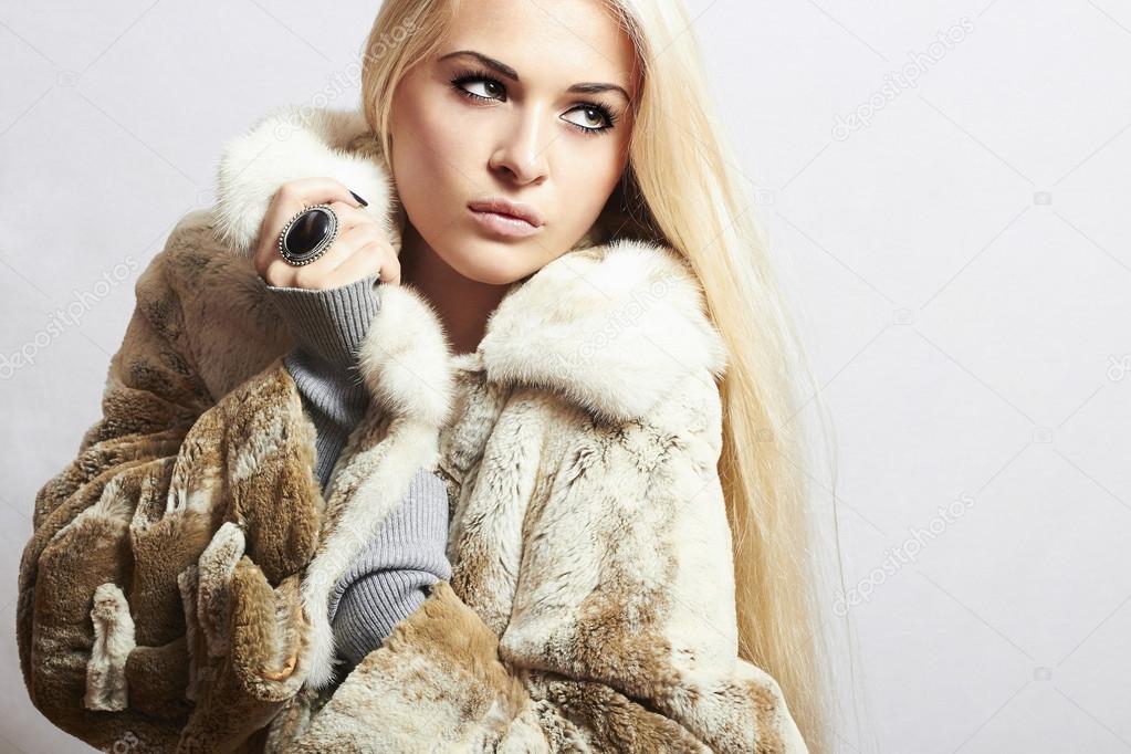 Young beautiful woman in fur. winter style.pretty girl. Beauty blond Model Girl in Mink Fur Coat.lady with big ring