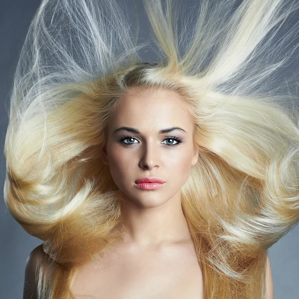 Young beautiful woman. Sexy blond girl. Beauty salon.Haircare.Flying hair — Stock Photo, Image