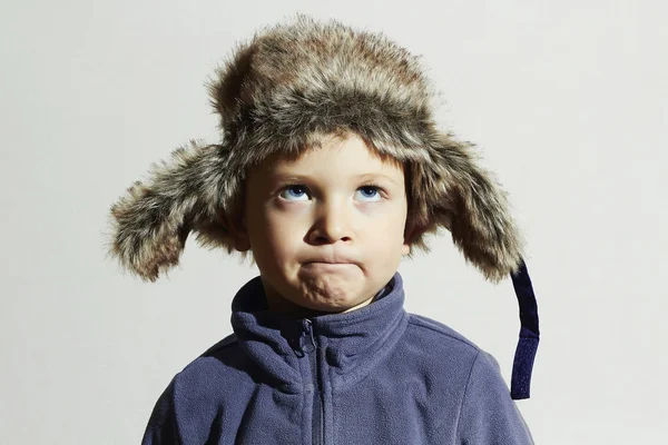 Sad child in fur Hat.Kids casual winter style.close-up funny portrait of little boy.children emotion — Stock Photo, Image