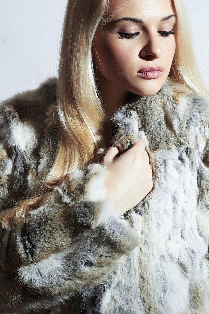 Beautiful woman in fur.winter fashion.Beauty blond Girl in Rabbit Fur Coat.Luxury Fur Jacket