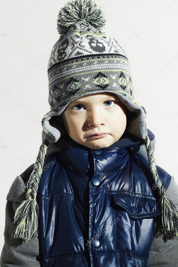 Sad child.winter fashion kids.fashionable little boy in cap