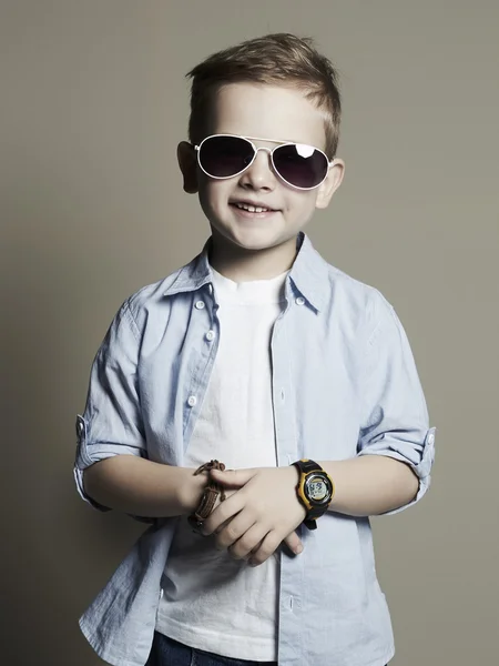 Funny child.fashionable little boy in sunglasses.stylish kid in jeans — Stock Photo, Image