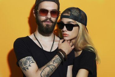 fashion beautiful couple together. Tattoo Hipster boy and girl. Bearded young man and blonde in sunglasses