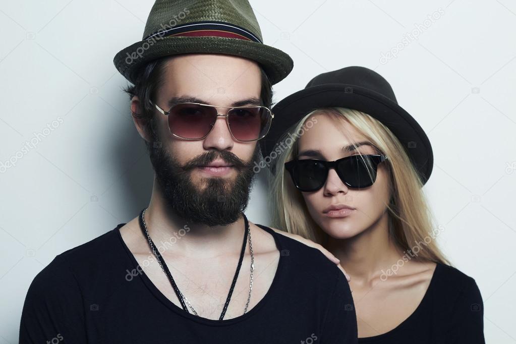 fashion beautiful couple in hat together. Hipster boy and girl in sunglasses