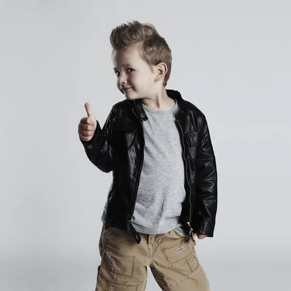 Fashionable child in leather coat.little boy hairstyle. Autumn funny smiling kid — Stok fotoğraf