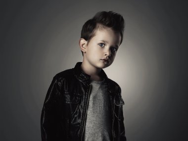 Handsome boy with trendy hairstyle.Fashionable child in leather