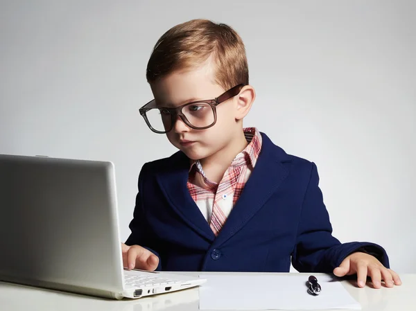 Young businessman using a laptop.child in glasses — Stock Photo, Image